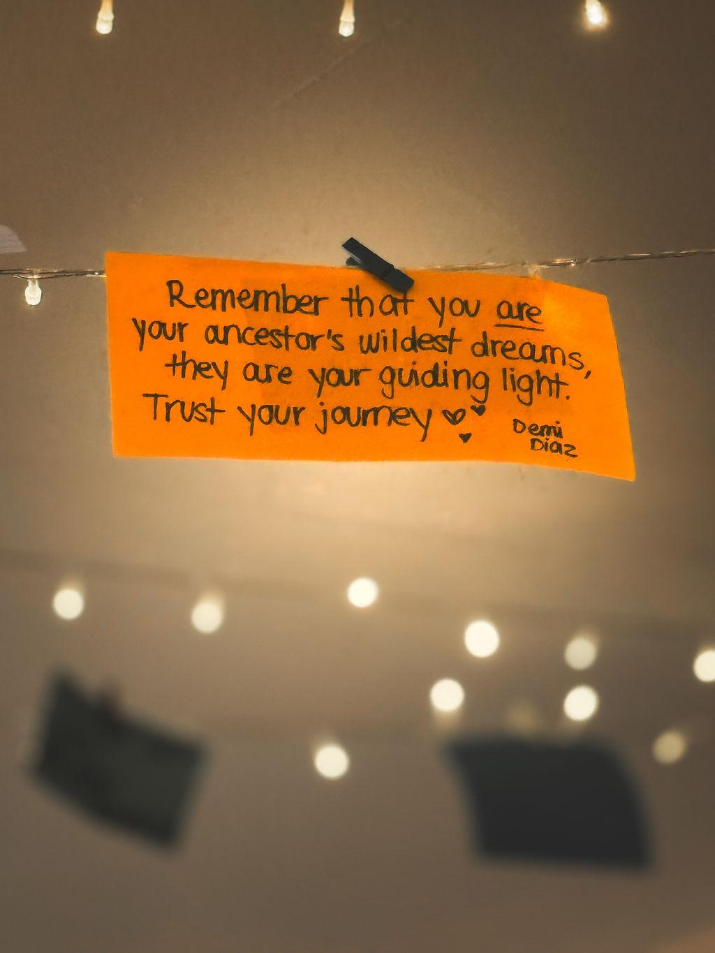 Handwritten note hanging among string lights